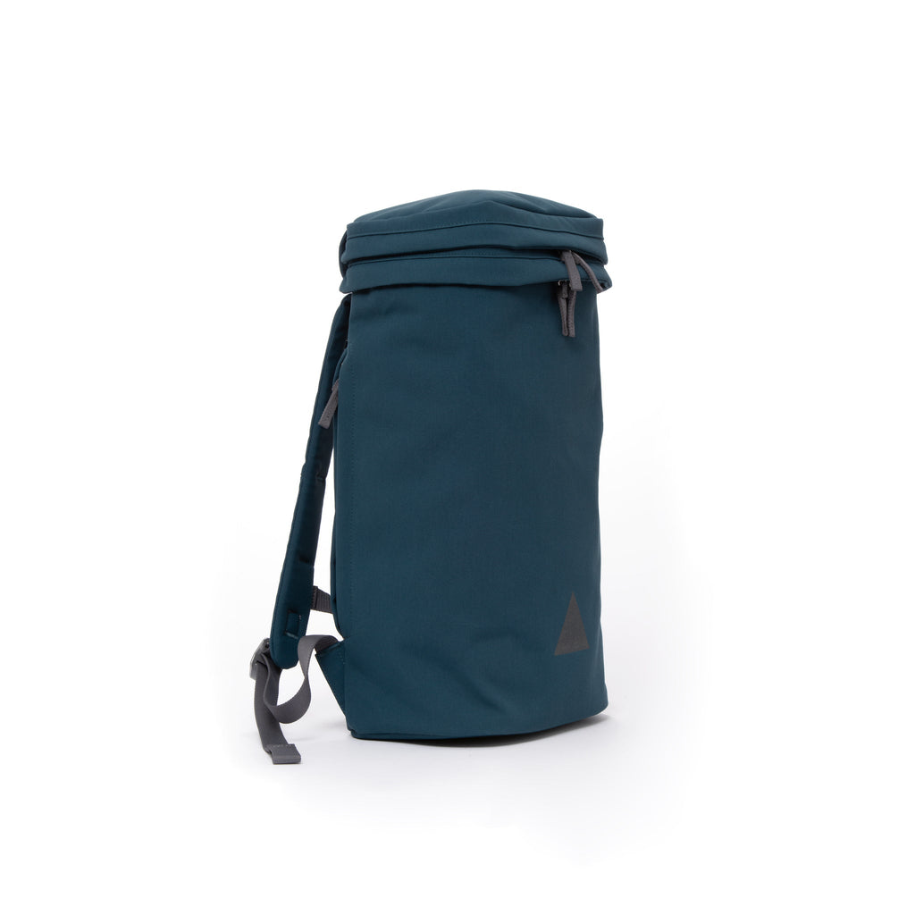 Blue canvas backpack with padded shoulder straps and triangle logo.