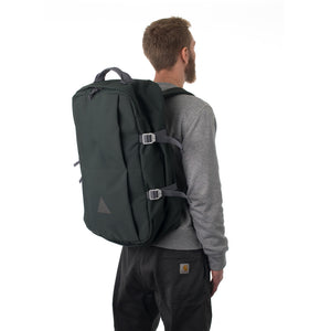 Man carrying grey travel backpack.