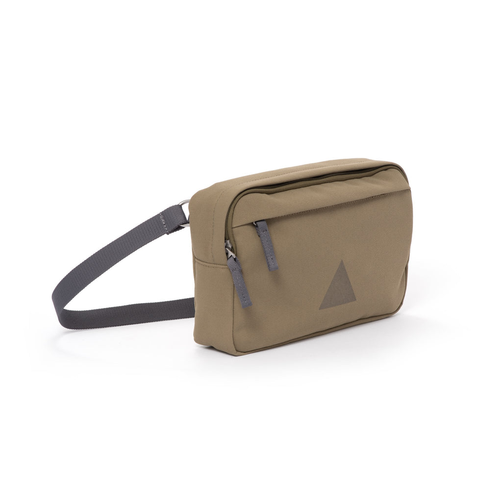 Khaki canvas shoulder bag with zip pockets and webbing strap.