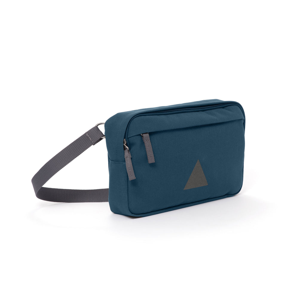 Blue canvas shoulder bag with zip pockets and webbing strap.