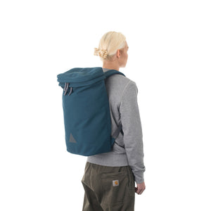 Woman wearing large blue backpack.
