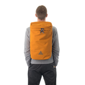 Man wearing large orange backpack with triangle logo.