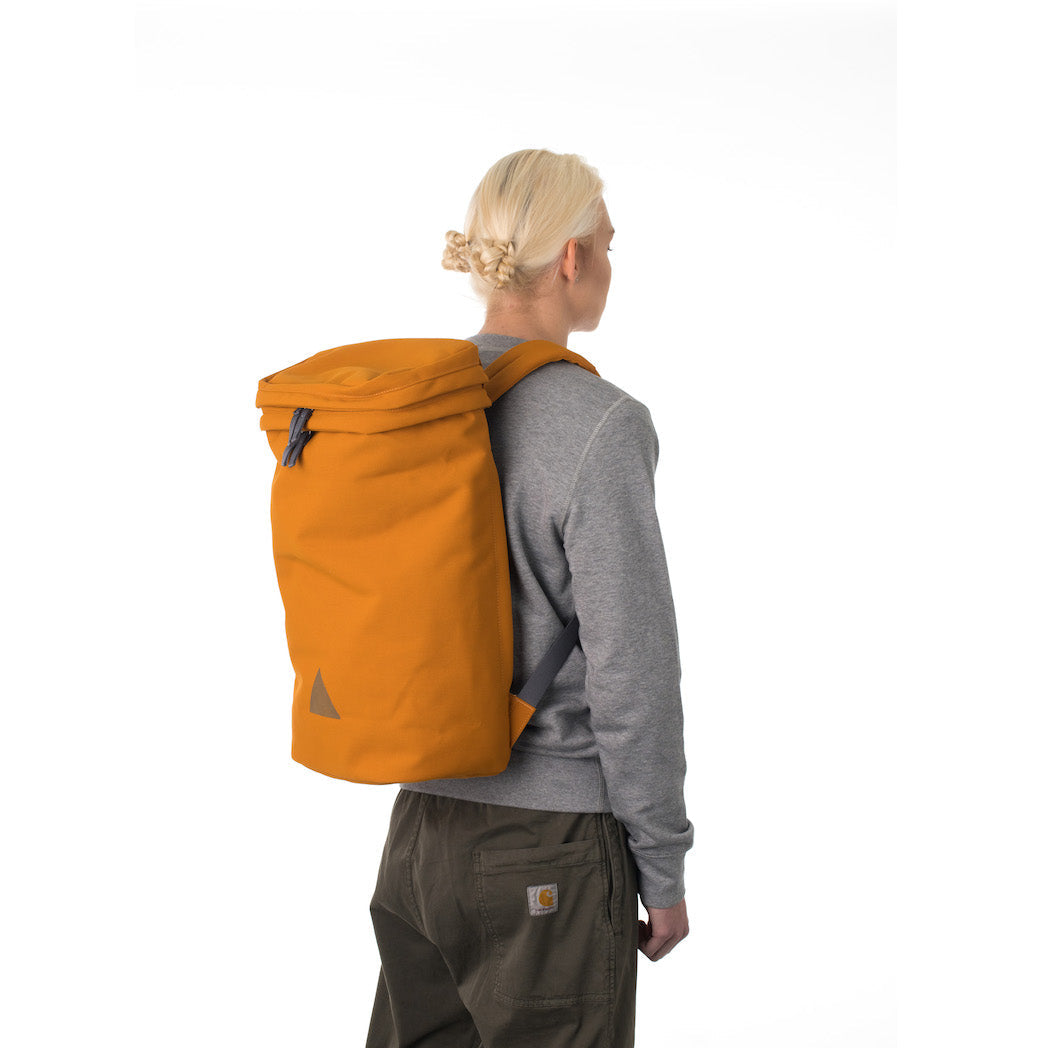 Woman wearing large orange backpack.