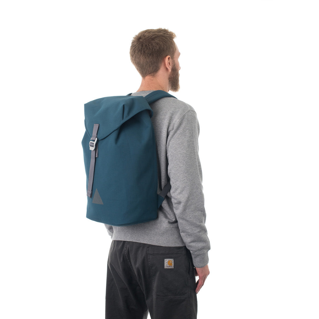 Man carrying blue flap backpack.