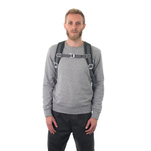 Man wearing grey backpack with padded shoulder straps.