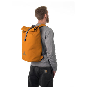 Man carrying orange rolltop backpack.