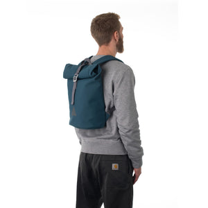 Man carrying blue rolltop backpack.