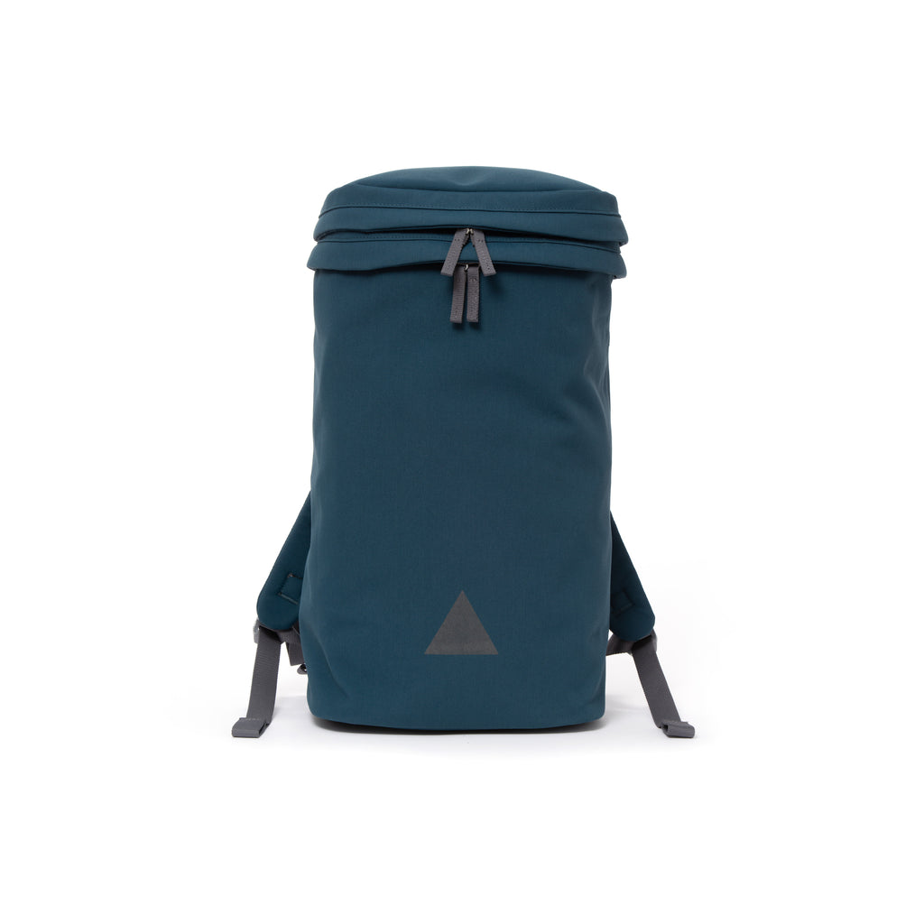 Blue canvas backpack with zip opening, padded shoulder straps and triangle logo.