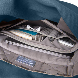 Blue backpack organiser pocket with guidebook and earphones.