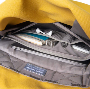 Yellow backpack organiser pocket with guidebook and earphones.
