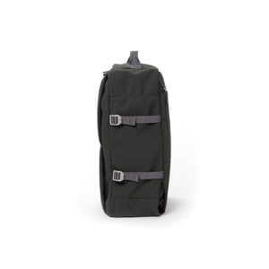 Grey waterproof canvas travel backpack with compression side straps.
