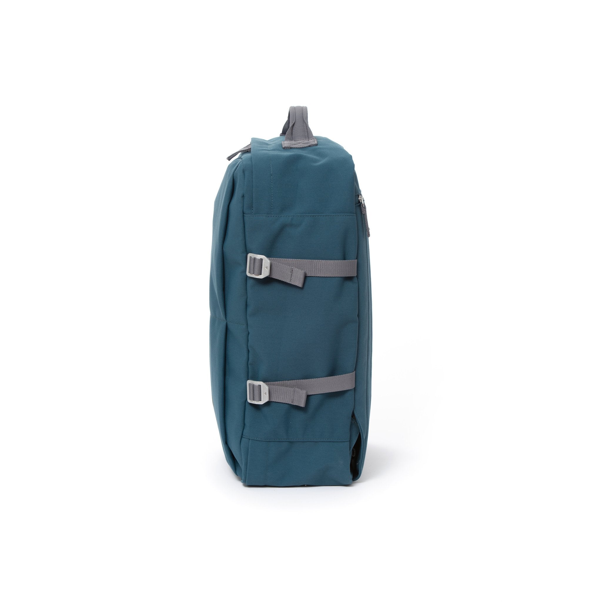 Blue waterproof canvas travel backpack with compression side straps.