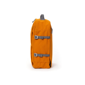 Orange waterproof canvas travel backpack with compression side straps.