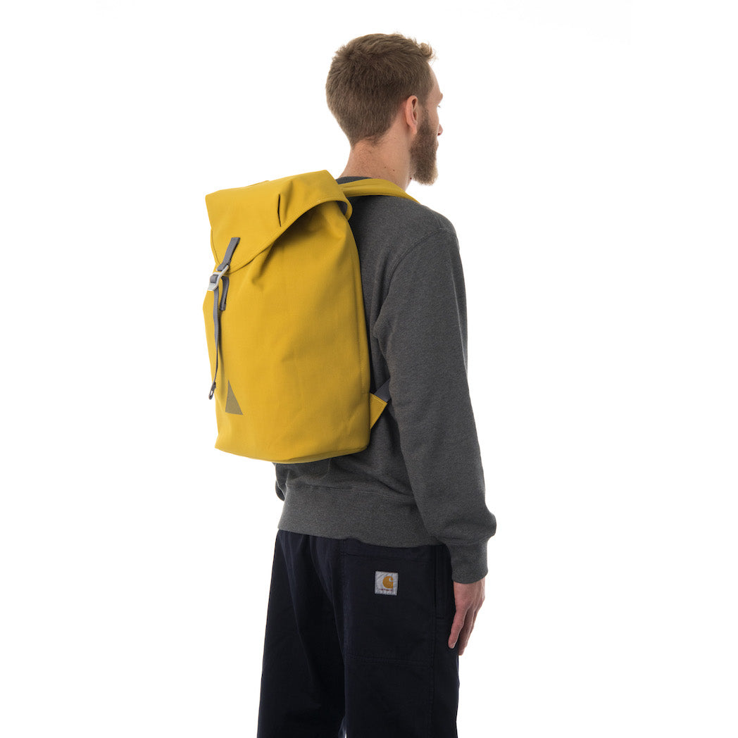 Man carrying yellow flap backpack.