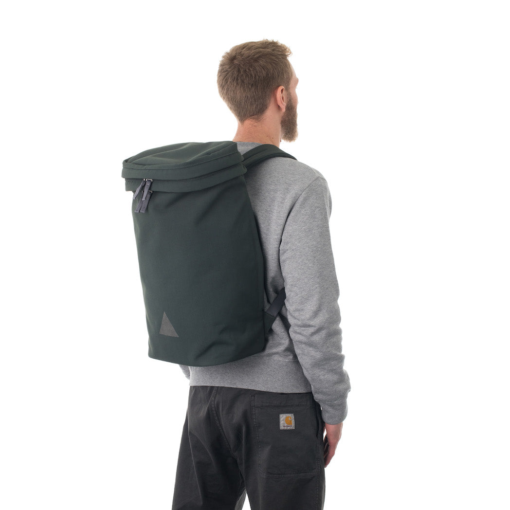 Man wearing large grey canvas backpack.