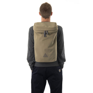 Man wearing large khaki backpack with triangle logo.